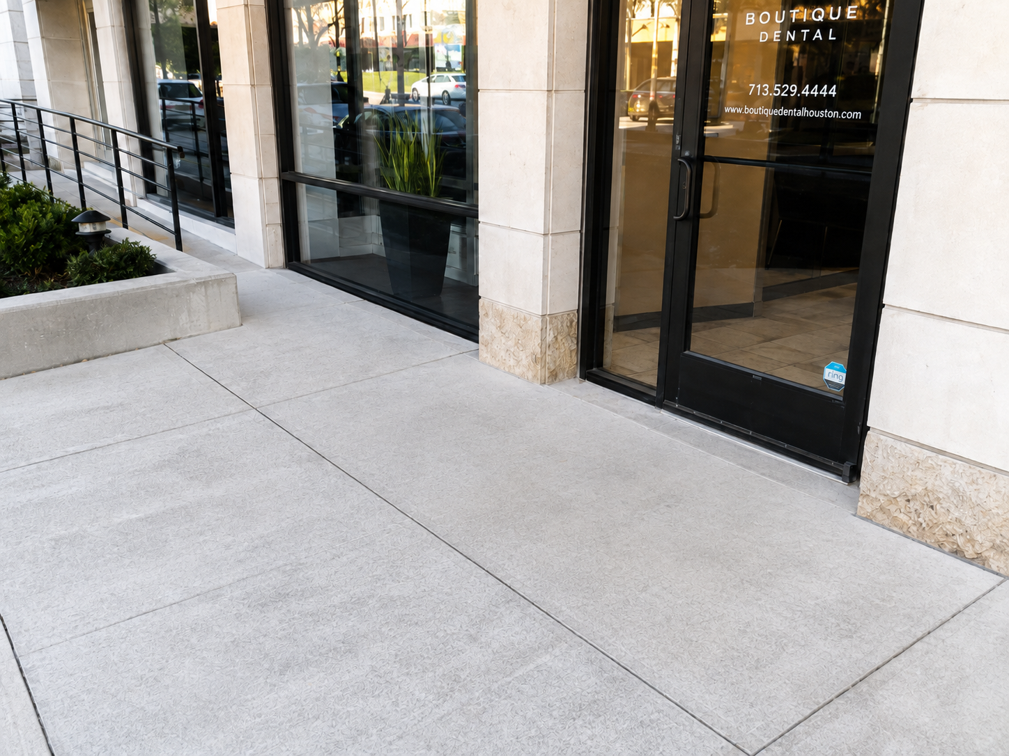 Clean storefront entrance with freshly washed entry concrete